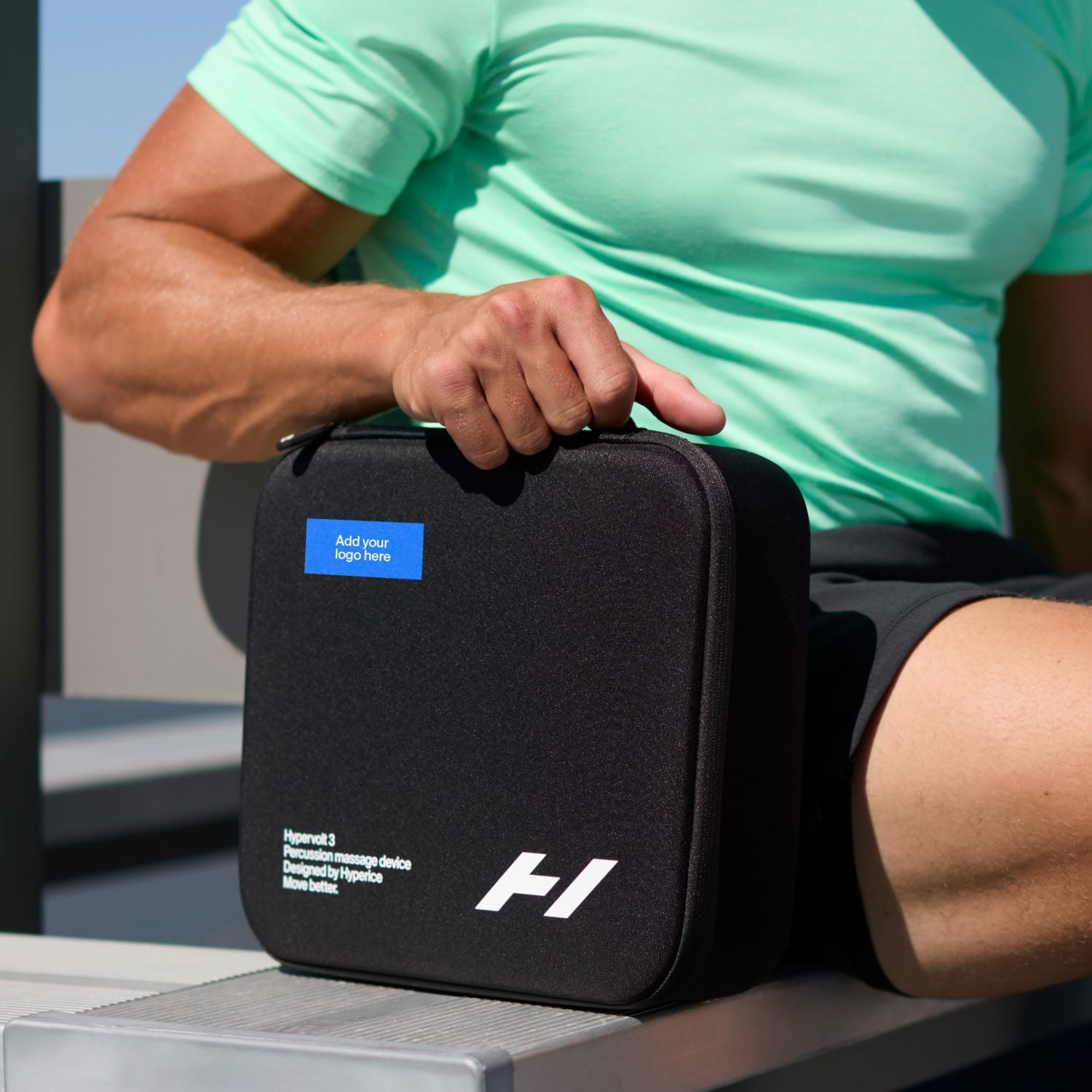 man on bench holding hypervolt 3 carry case