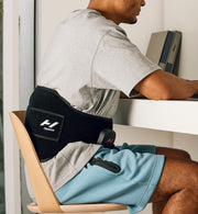 Person wearing a venom 2 back on their back while sitting at a desk.